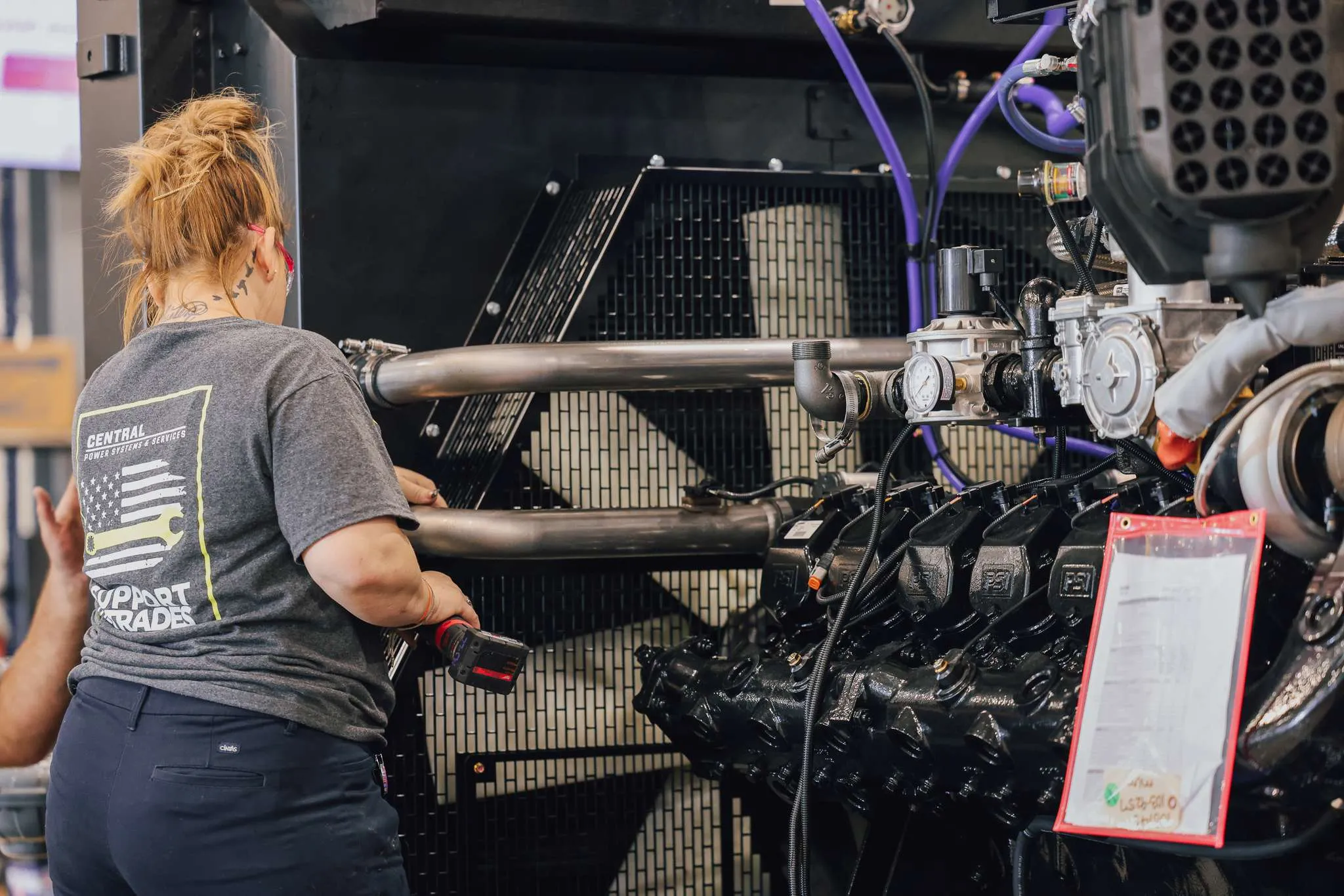 A woman technician working at the Platte City manufacturing facility.